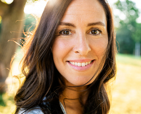 Portrait einer jungen Frau im Garten.